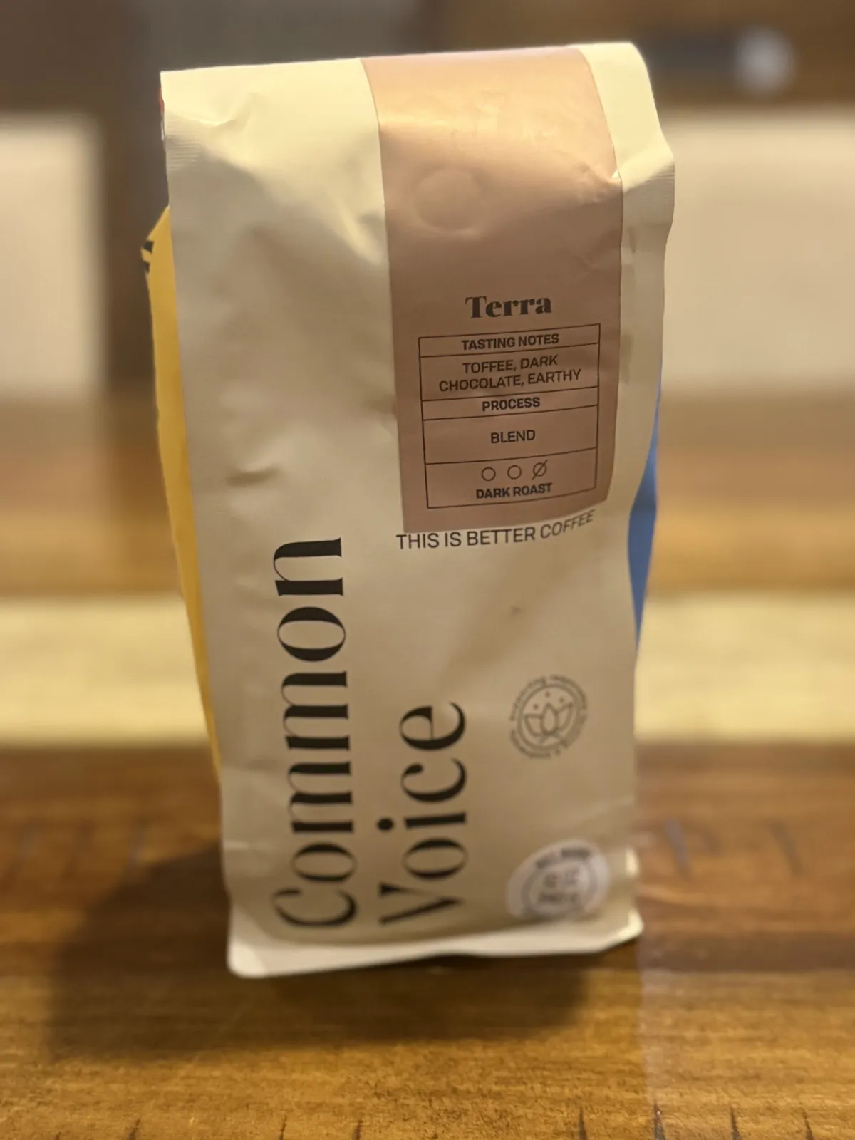 Front of the Common Voice "Terra" 12 oz bag; the label lists tasting notes toffee, dark chocolate, earthy, process blend, dark roast