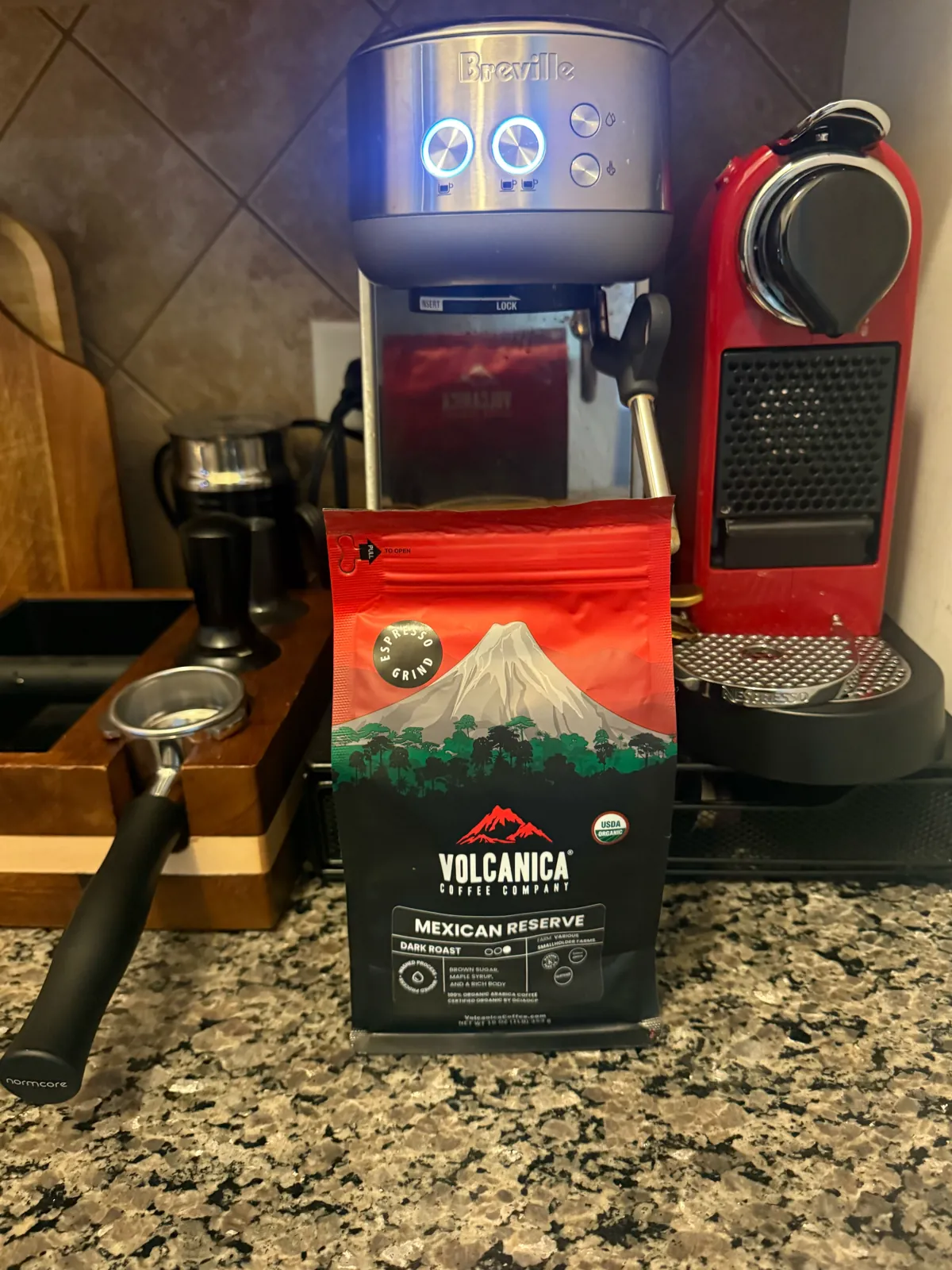 Volcanica bag on the counter in front of a Breville espresso machine