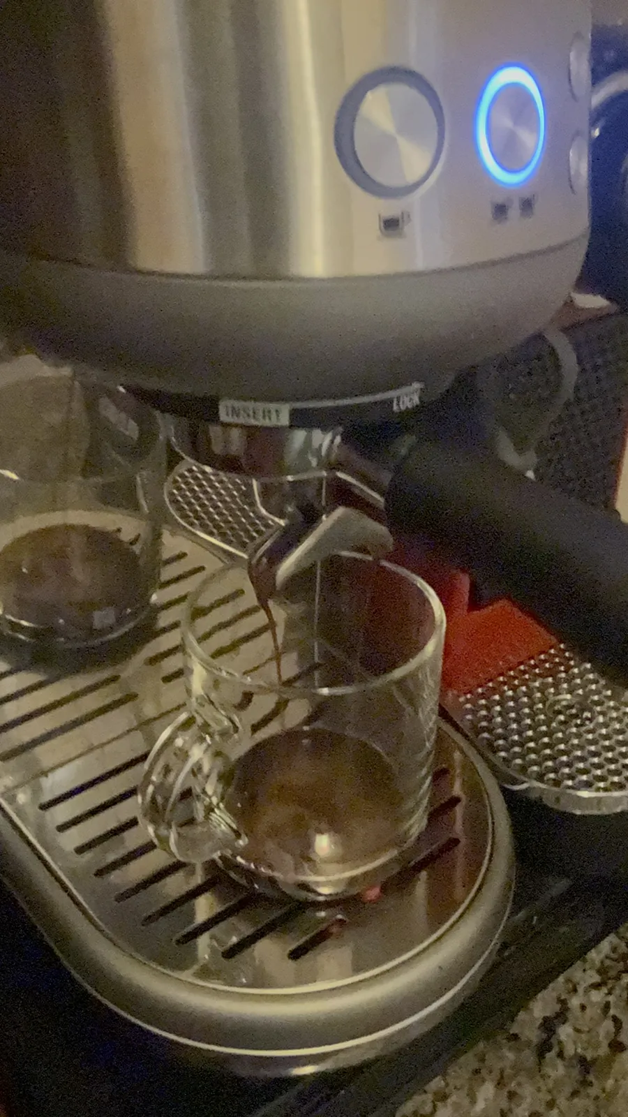Espresso pulling from a Breville machine into a clear glass